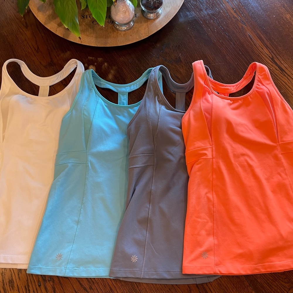 Athleta brand exercise tops. set of 4, built in padded bra, excellent condition
